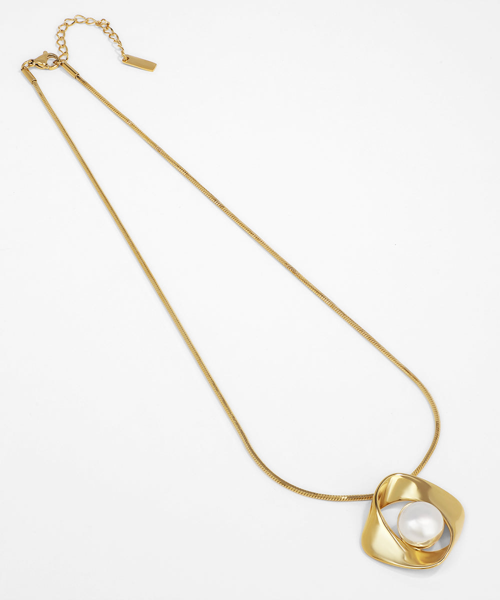 Gold necklace with a pendant on a white background