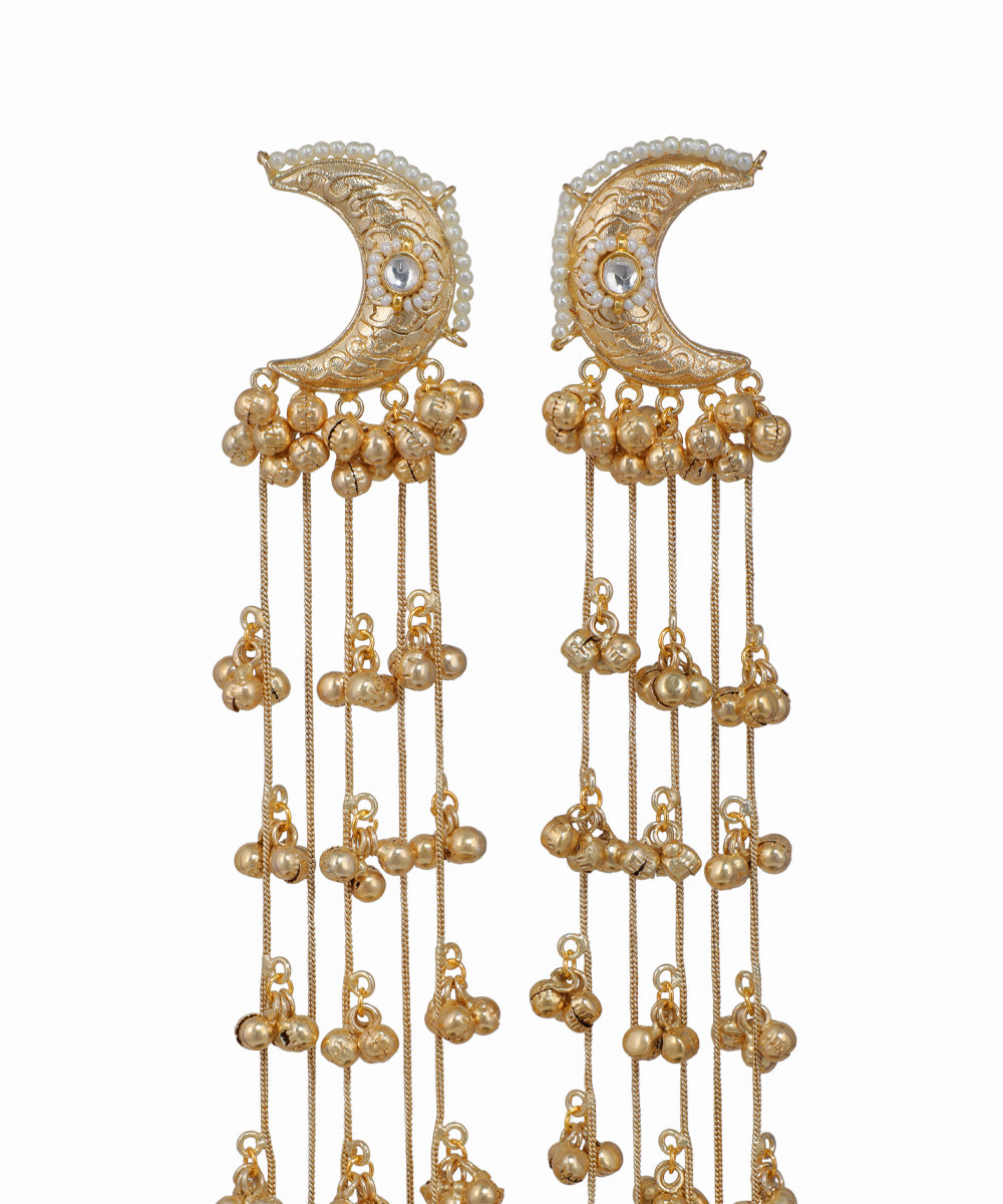 Pair of gold earrings with crescent moon design and dangling beads on a white background