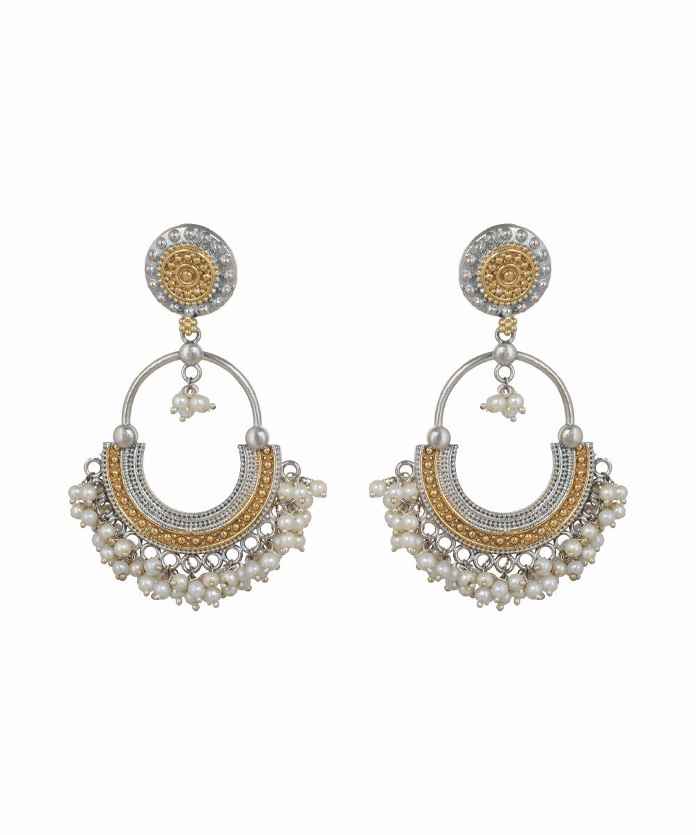 Pair of gold and silver earrings with pearl accents on a white background