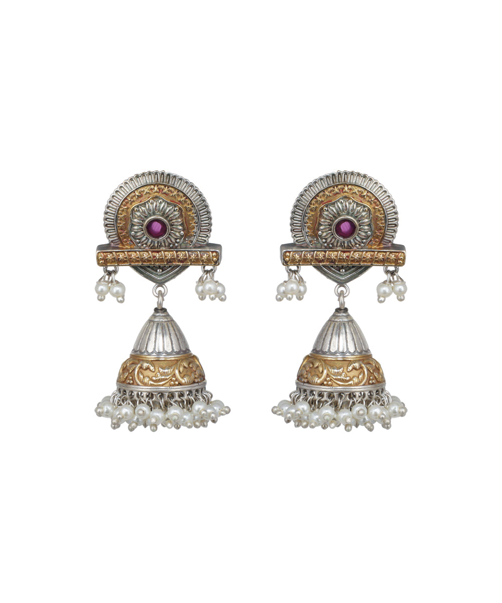 Pair of ornate earrings with gold and silver design on a white background