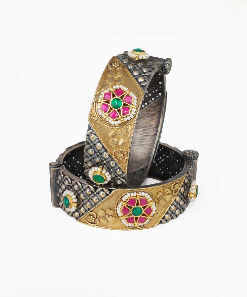 Decorative bracelet with gold and silver design on a white background