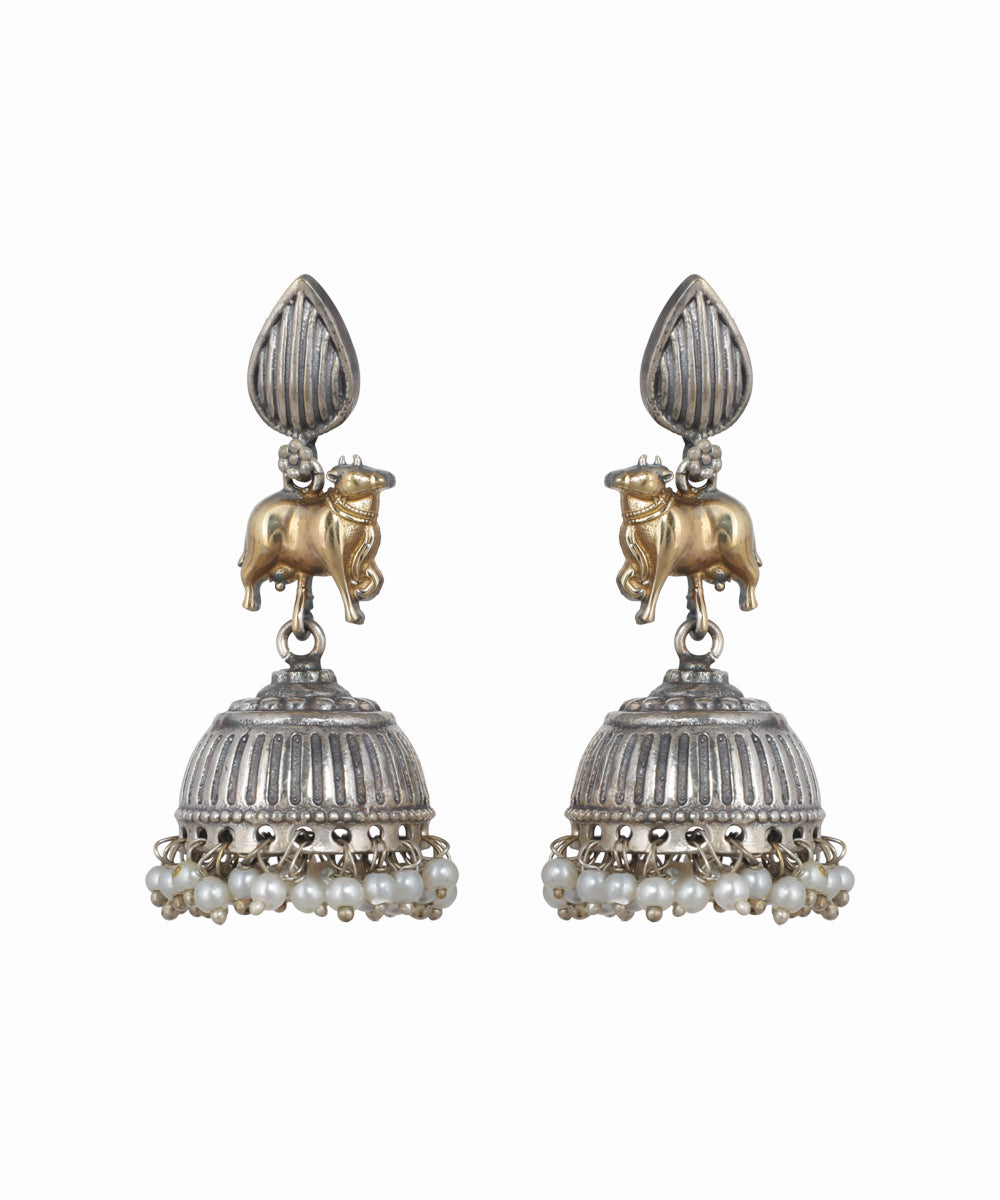 Pair of silver and gold earrings with pearl accents on a white background