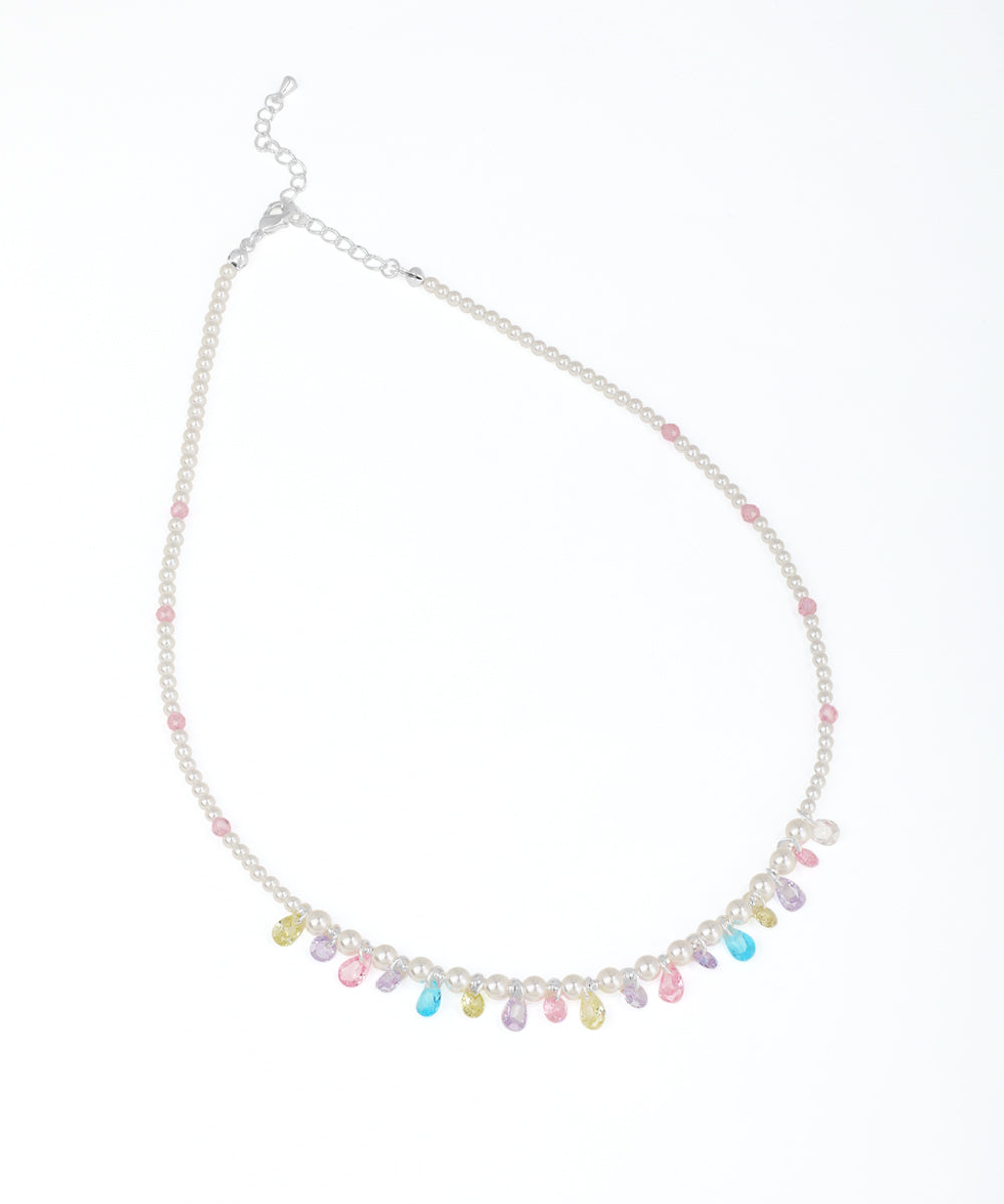 Rhodium finish beaded necklace with faux pearls, small pink beads, and colorful pastel teardrop glass crystals