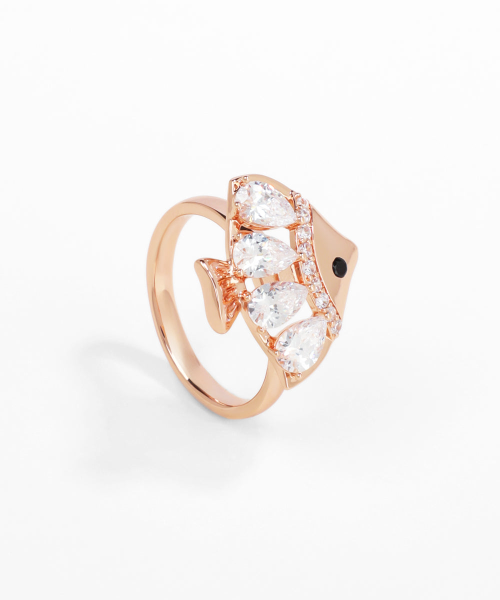 Rose gold ring with clear gemstones on a white background