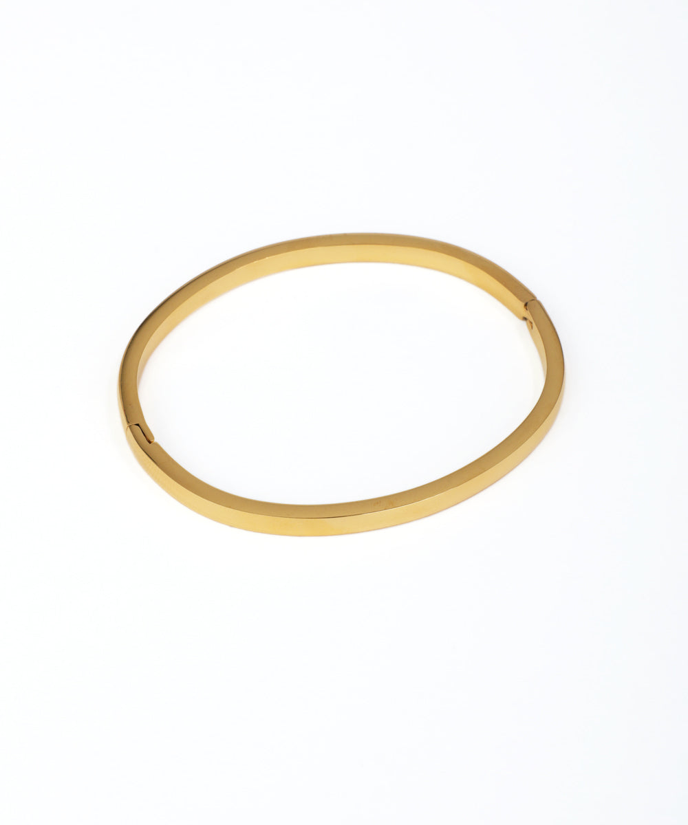 Gold bangle on a white background