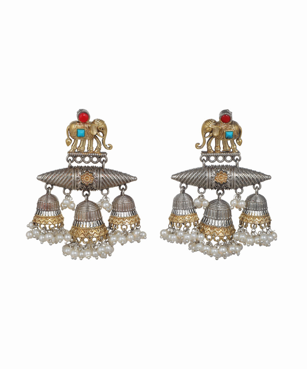 Pair of ornate earrings with elephant design on a white background
