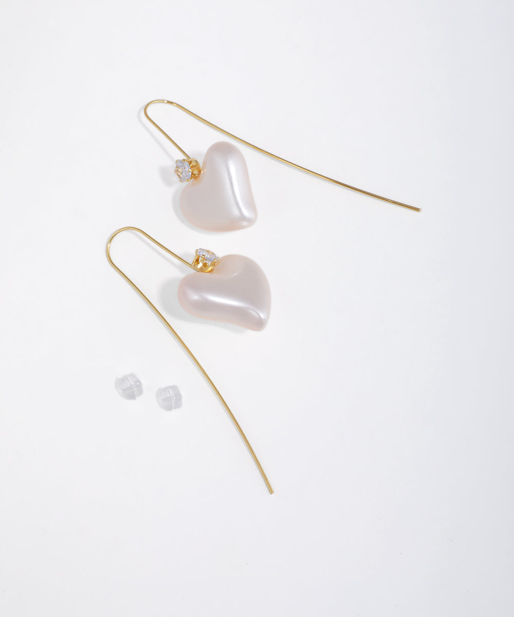Gold-tone drop earrings with pearlescent puffed hearts and small clear stones