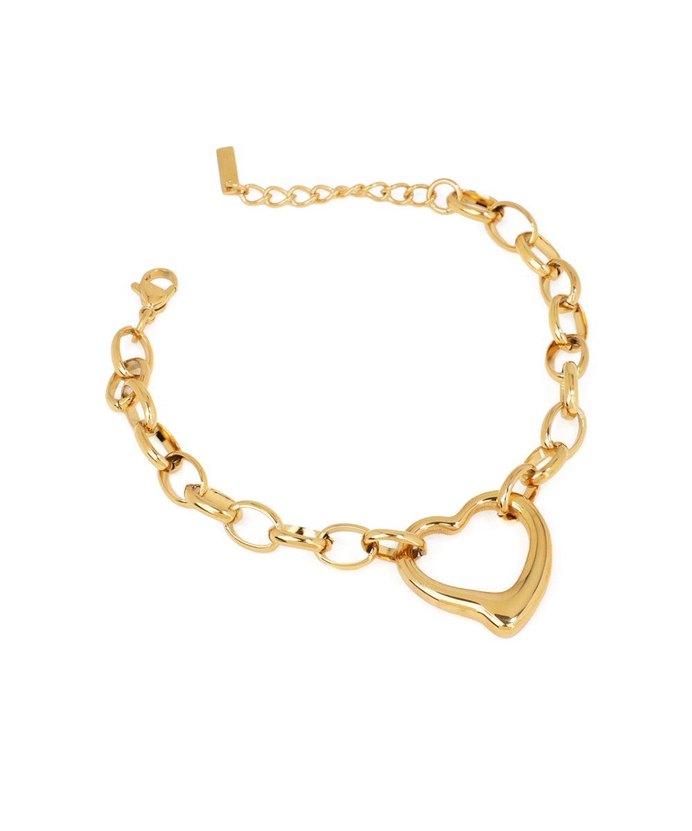 Gold-tone chain bracelet with chunky links and a large, polished puffy heart charm.