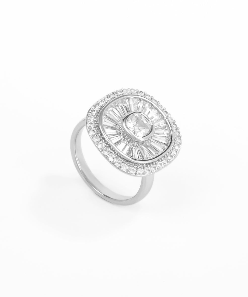Silver ring with a central gemstone and smaller stones on a white background