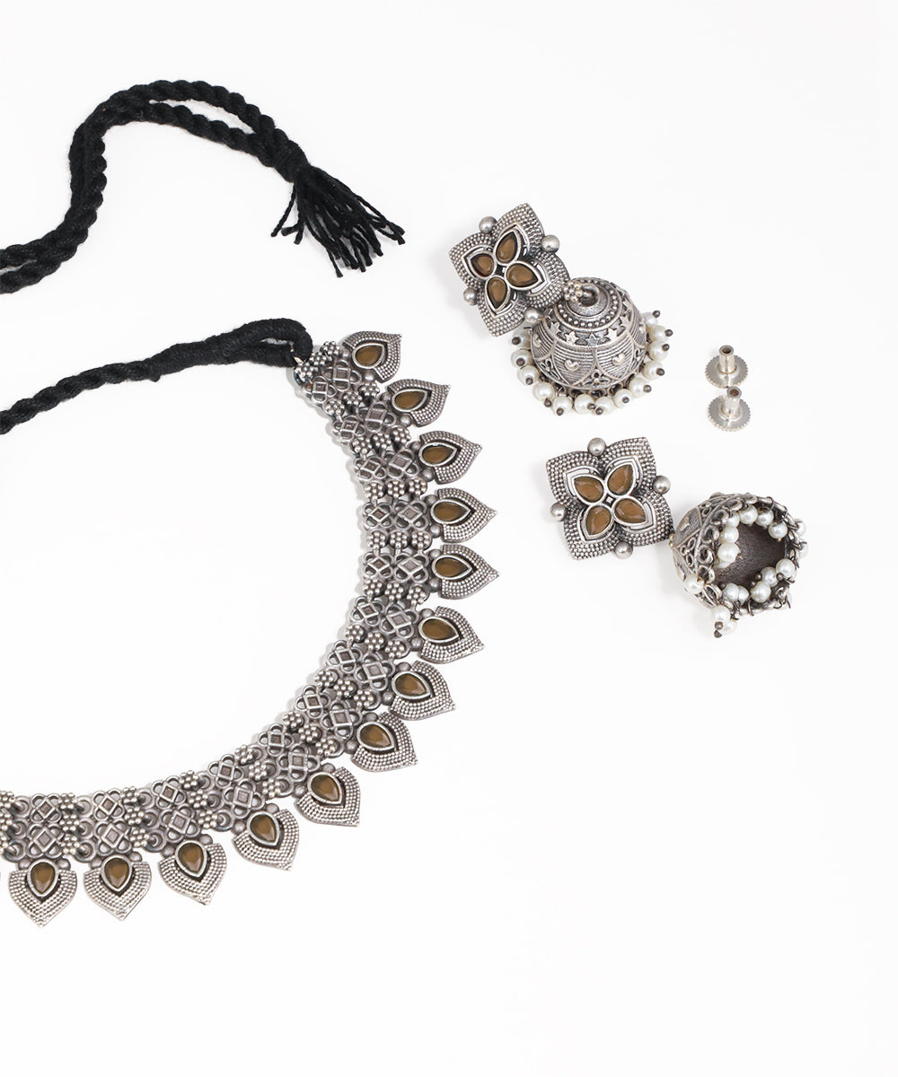 Silver necklace with matching earrings on a white background