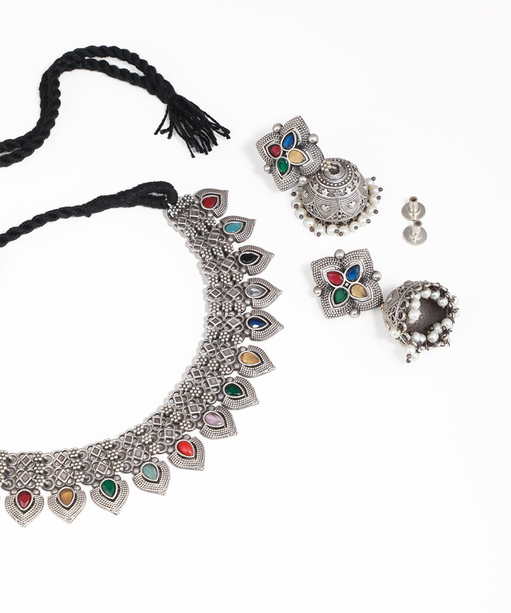 Silver jewelry set with colorful stones on a white background