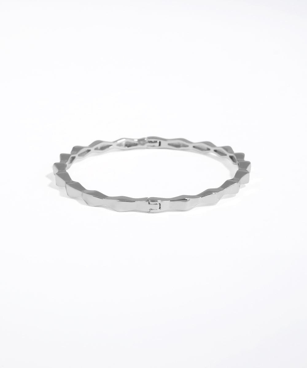 Silver ring with a textured band on a white background