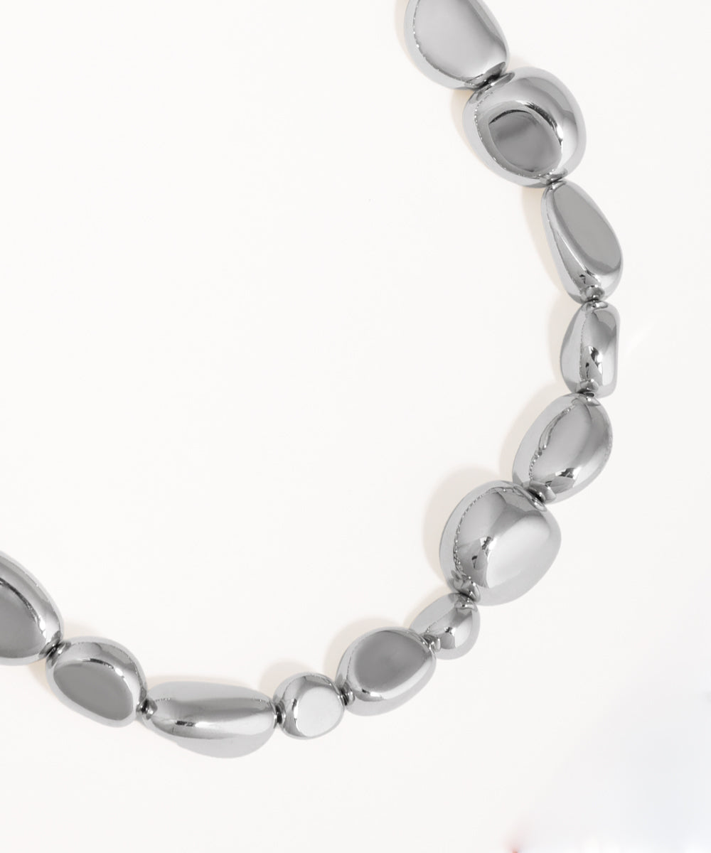 Silver beaded bracelet on a white background
