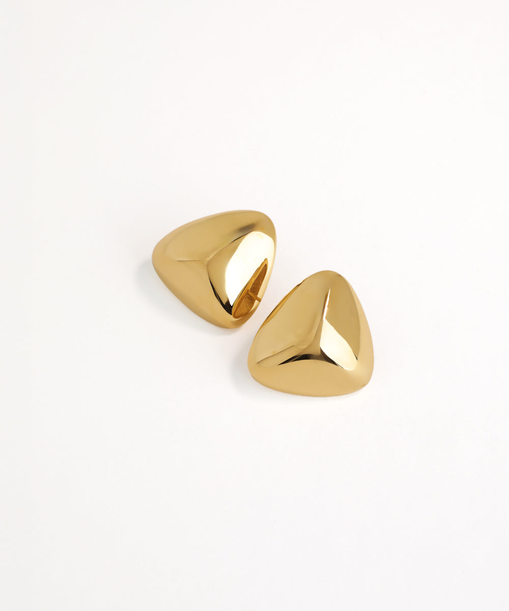 Pair of gold earrings on a white background