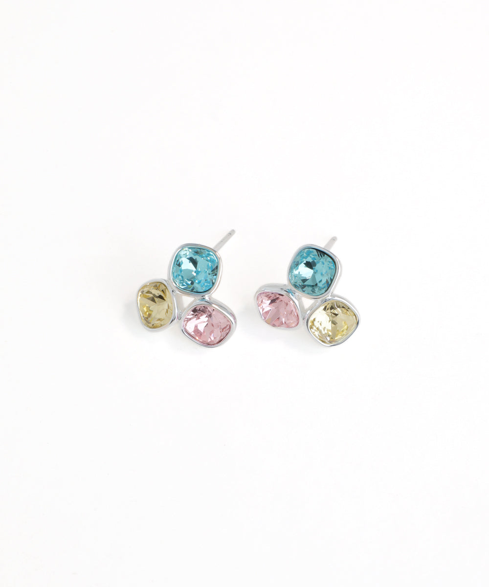 Pair of earrings with multicolored gemstones on a white background