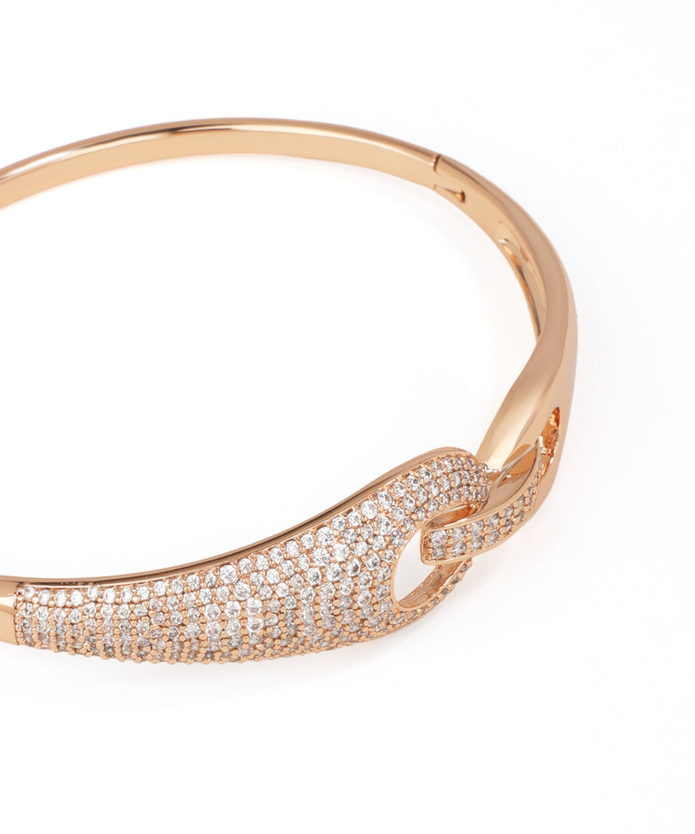 Rose gold bracelet with diamond accents on a white background