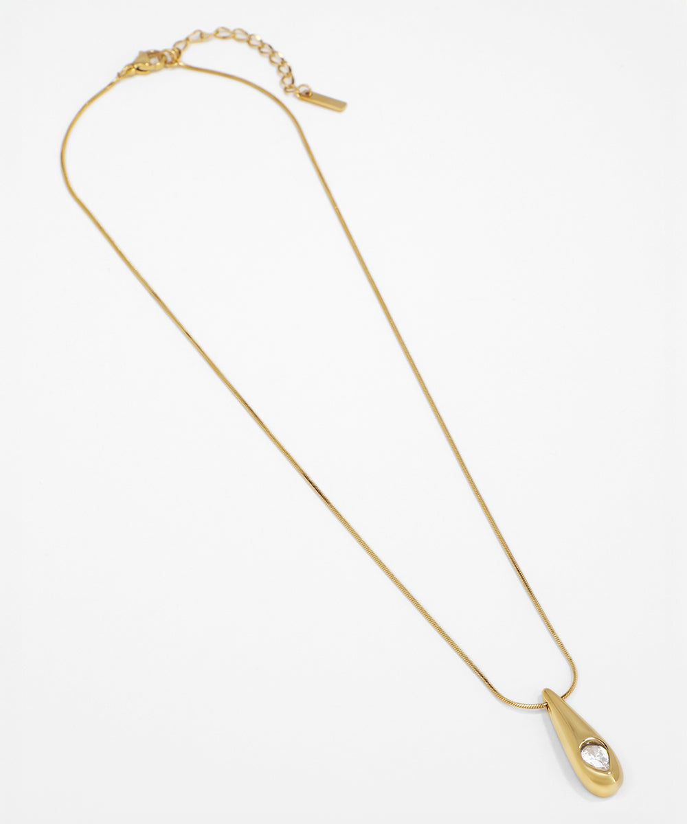 Gold necklace with a unique clasp on a white background