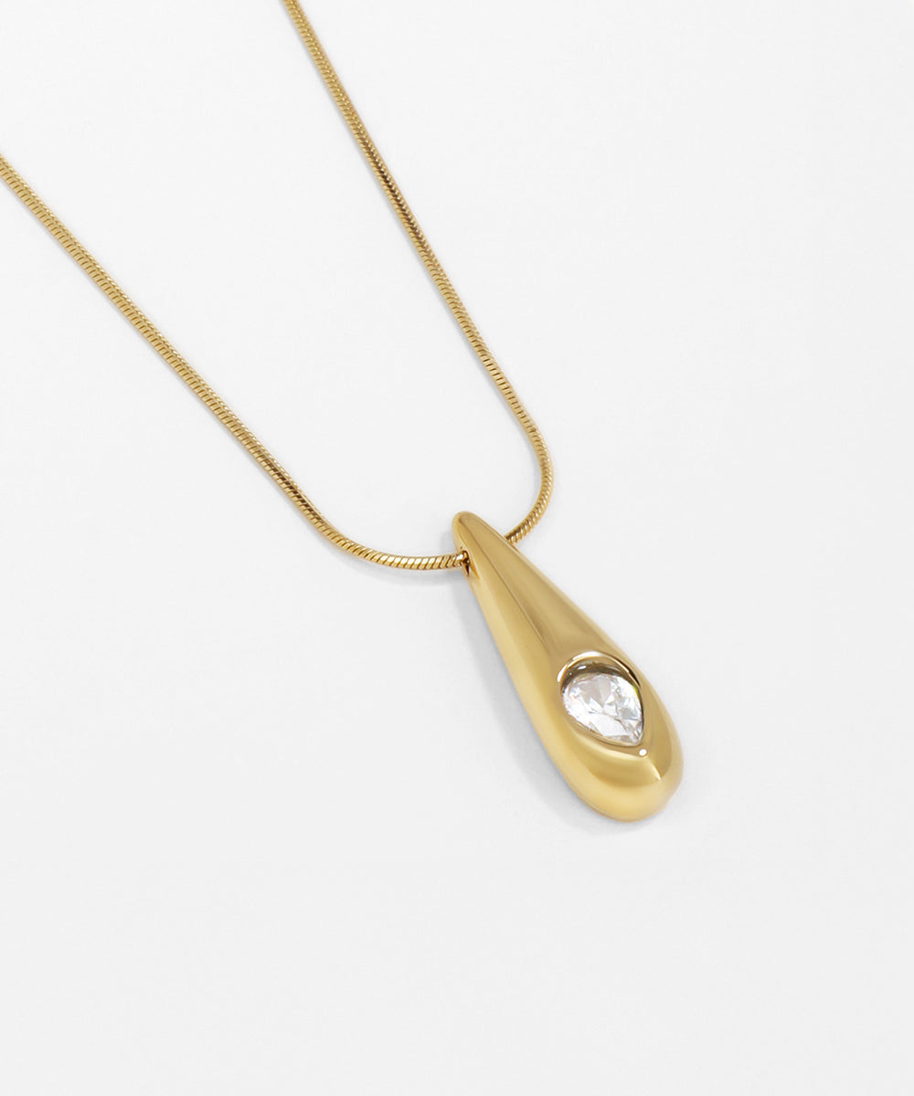 Gold necklace with a teardrop-shaped pendant on a white background