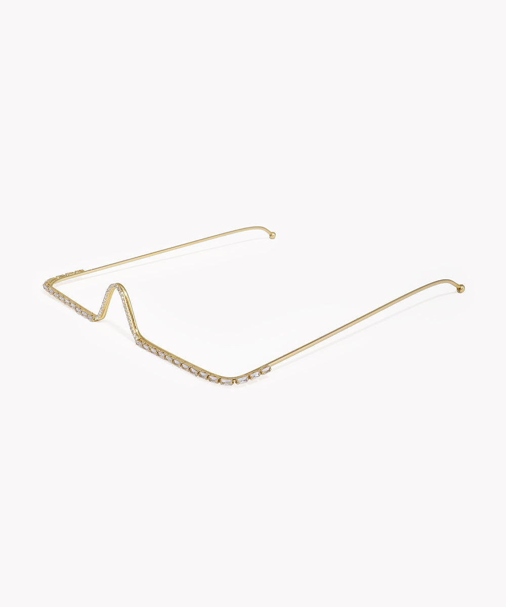 Gold cat-eye sunglasses frame on a white background