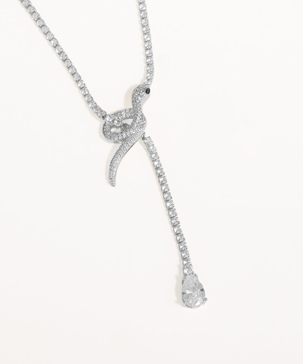 Silver snake-shaped pendant necklace on a white background