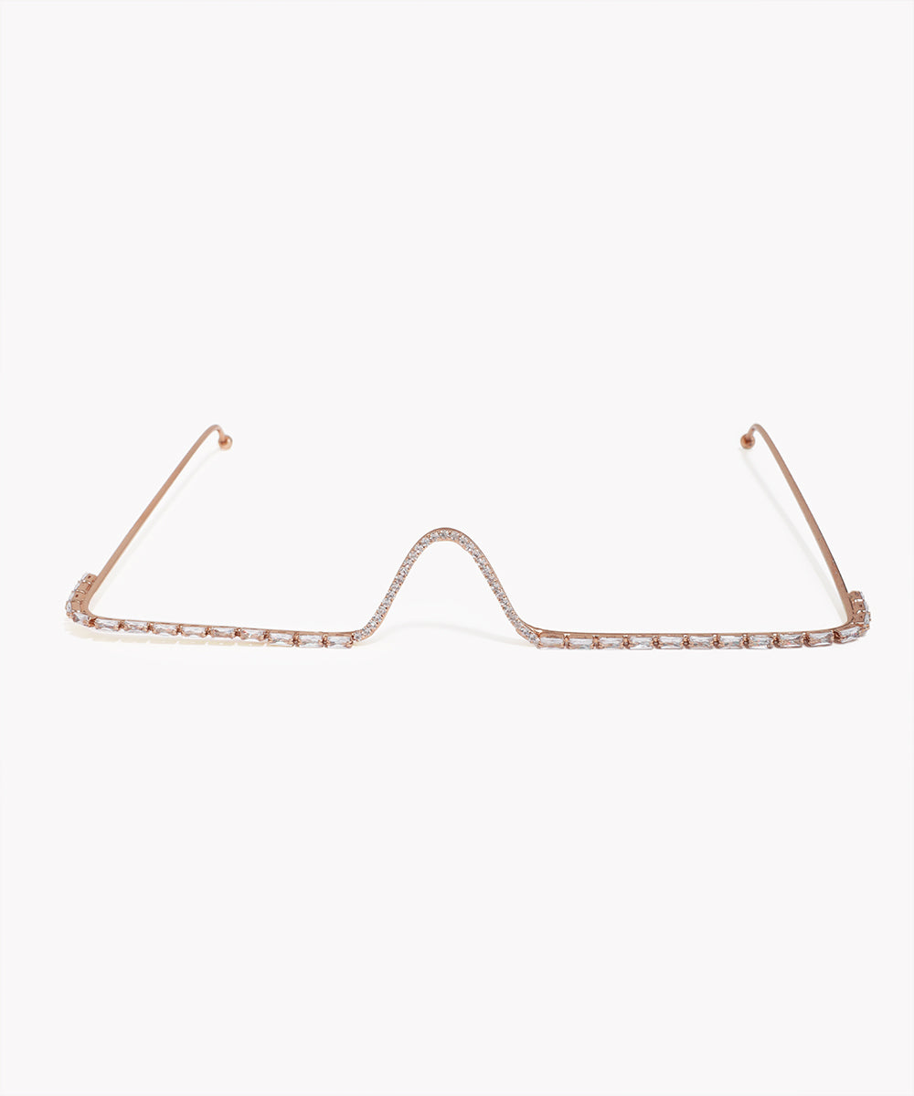 Rose gold eyeglass frame on a white background