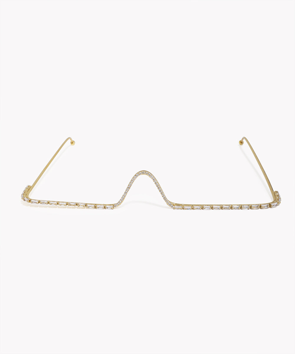 Gold-tone facelet with central wave design and clear baguette and pavé CZ stones.