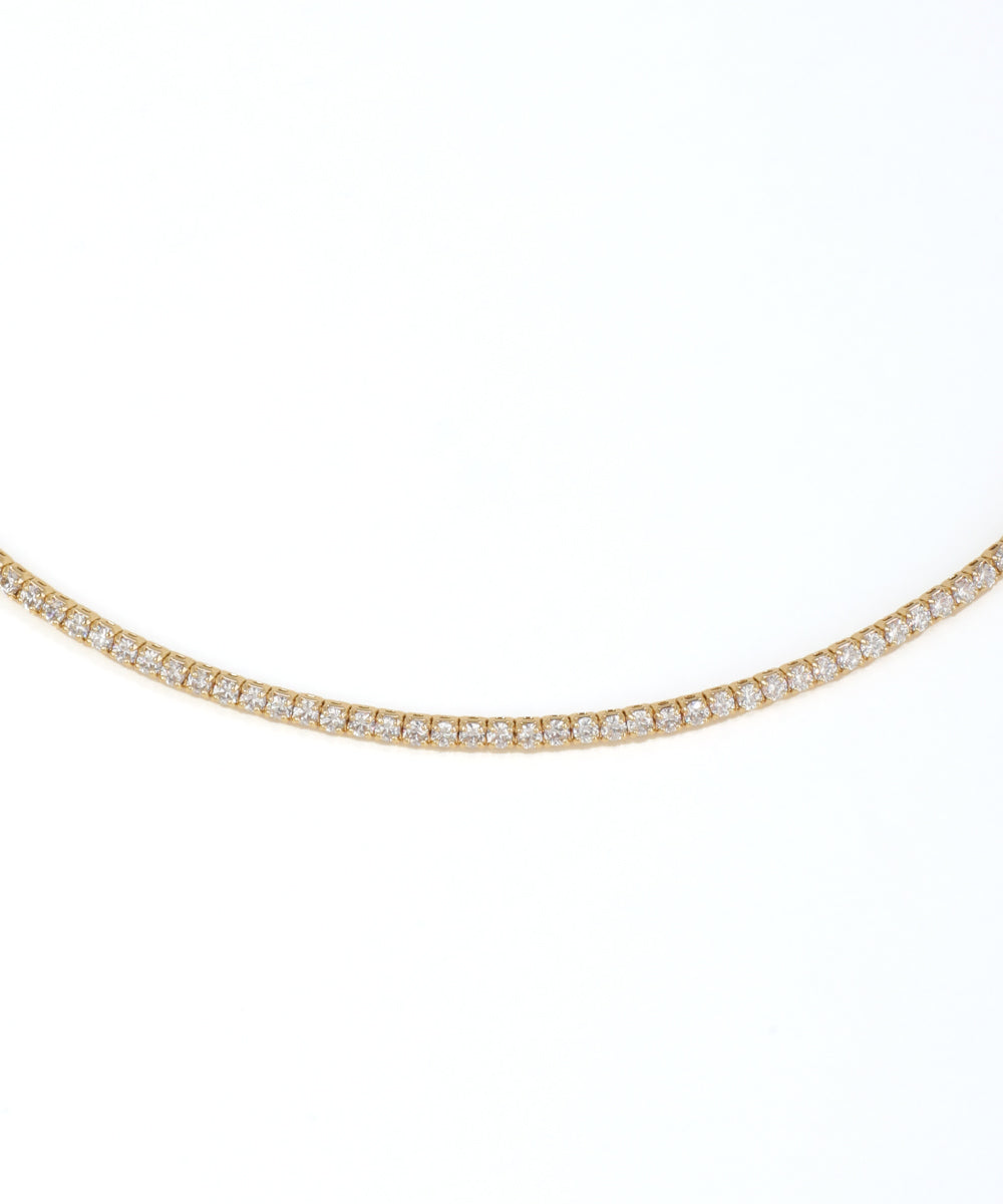 Gold necklace with diamonds on a white background