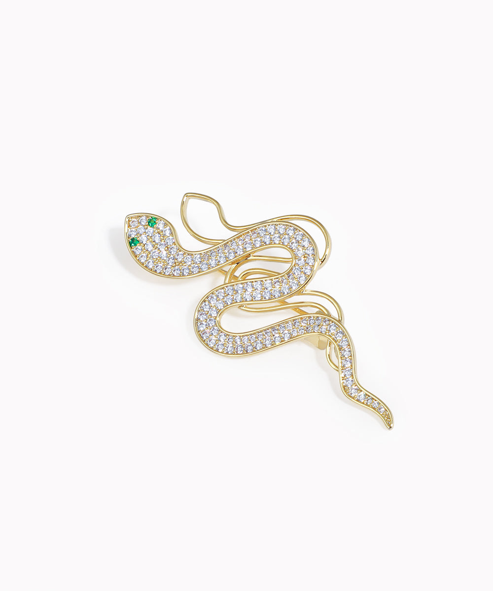 Gold-tone coiled serpent brooch pin with clear and green stones