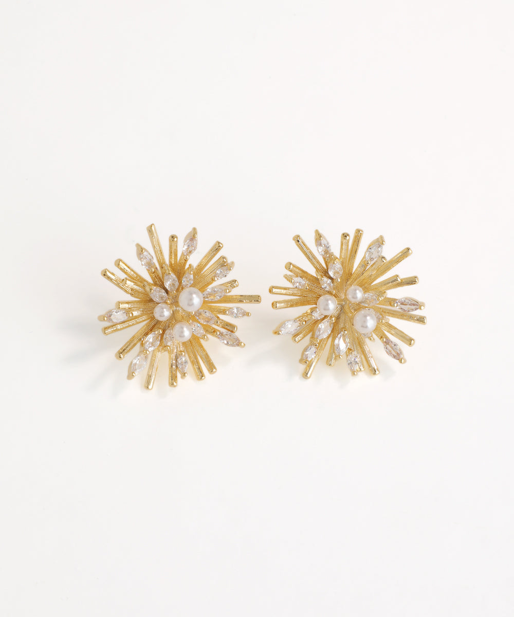 Gold and pearl earrings on a white background