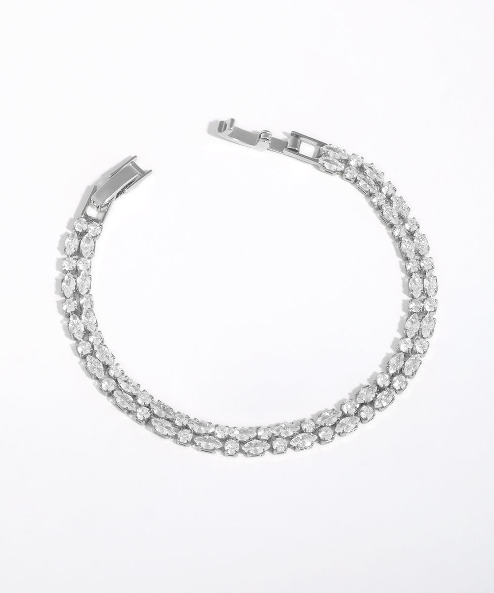 Silver bracelet with clear stones on a white background