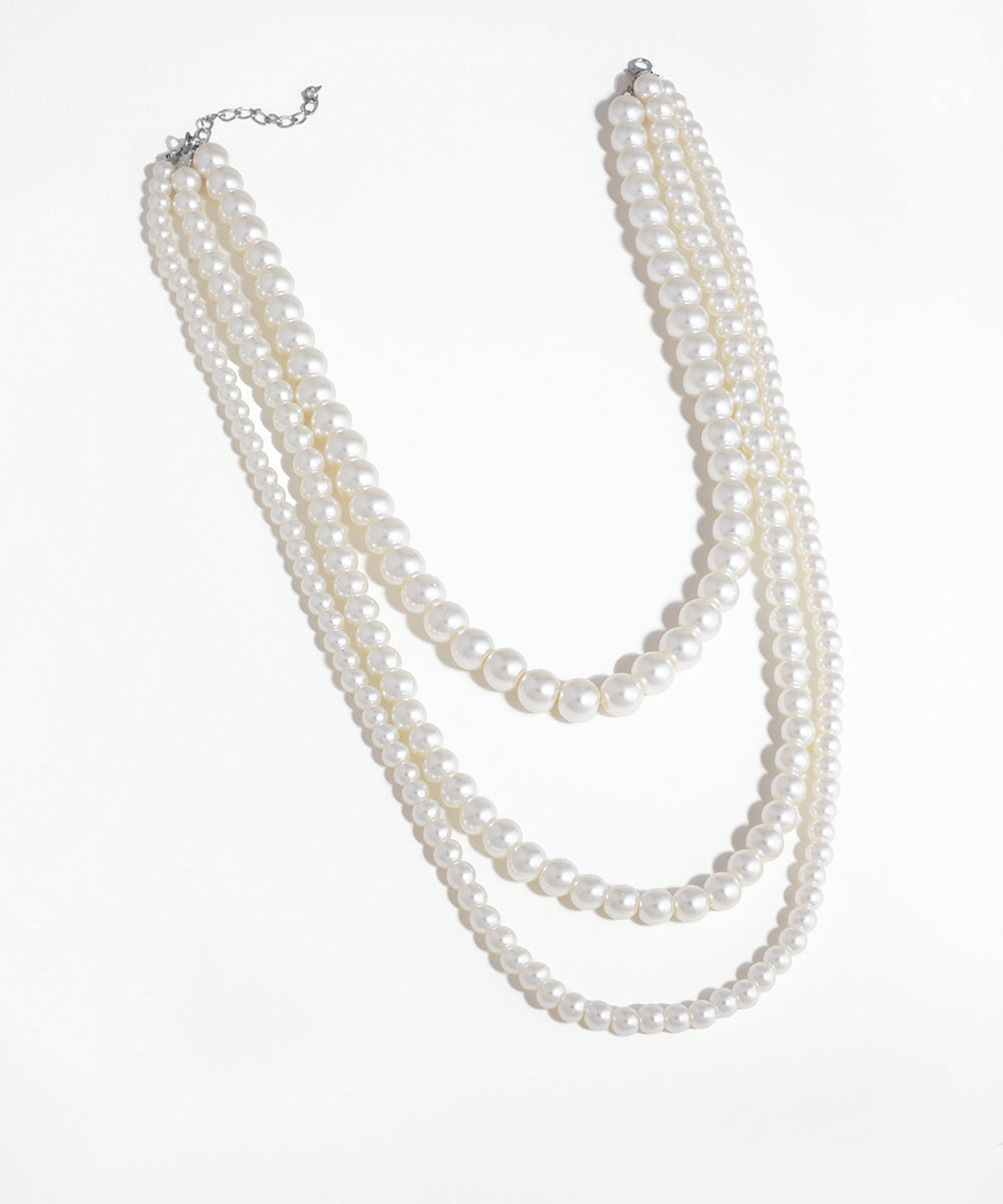 Silver-tone necklace with three layered strands of graduated faux pearls
