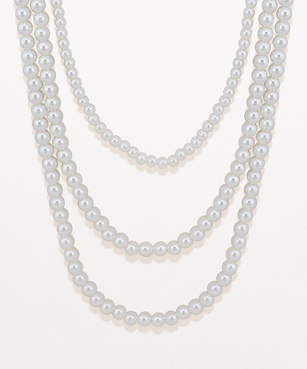 Two pearl necklaces on a white background