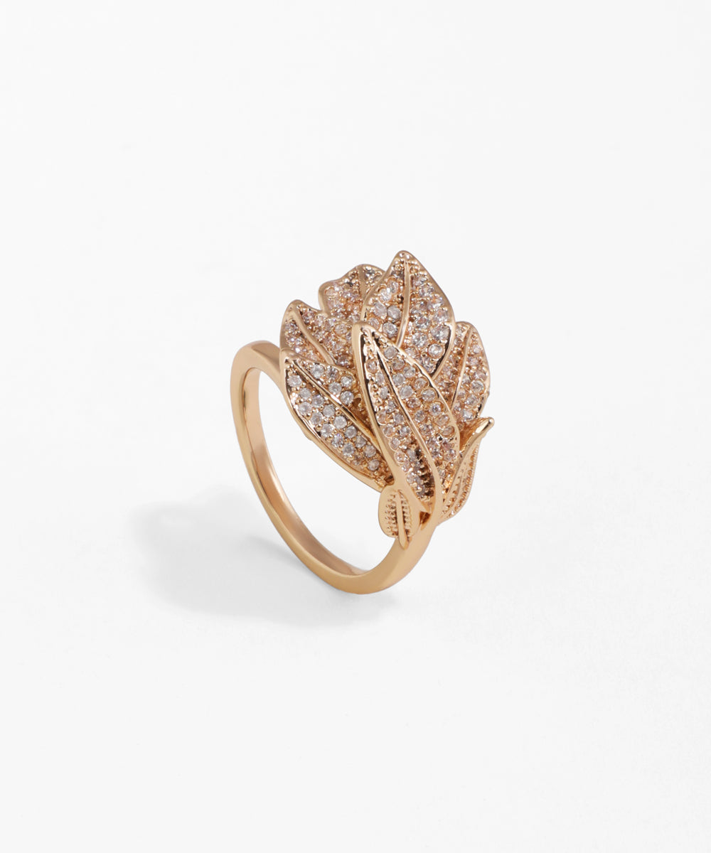Rose gold ring with leaf design and clear stones on a white background