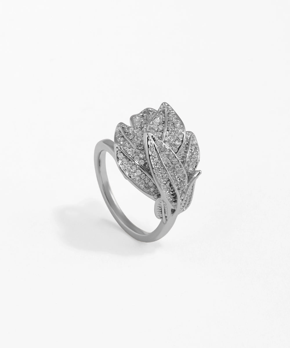 Silver ring with feather design on a white background