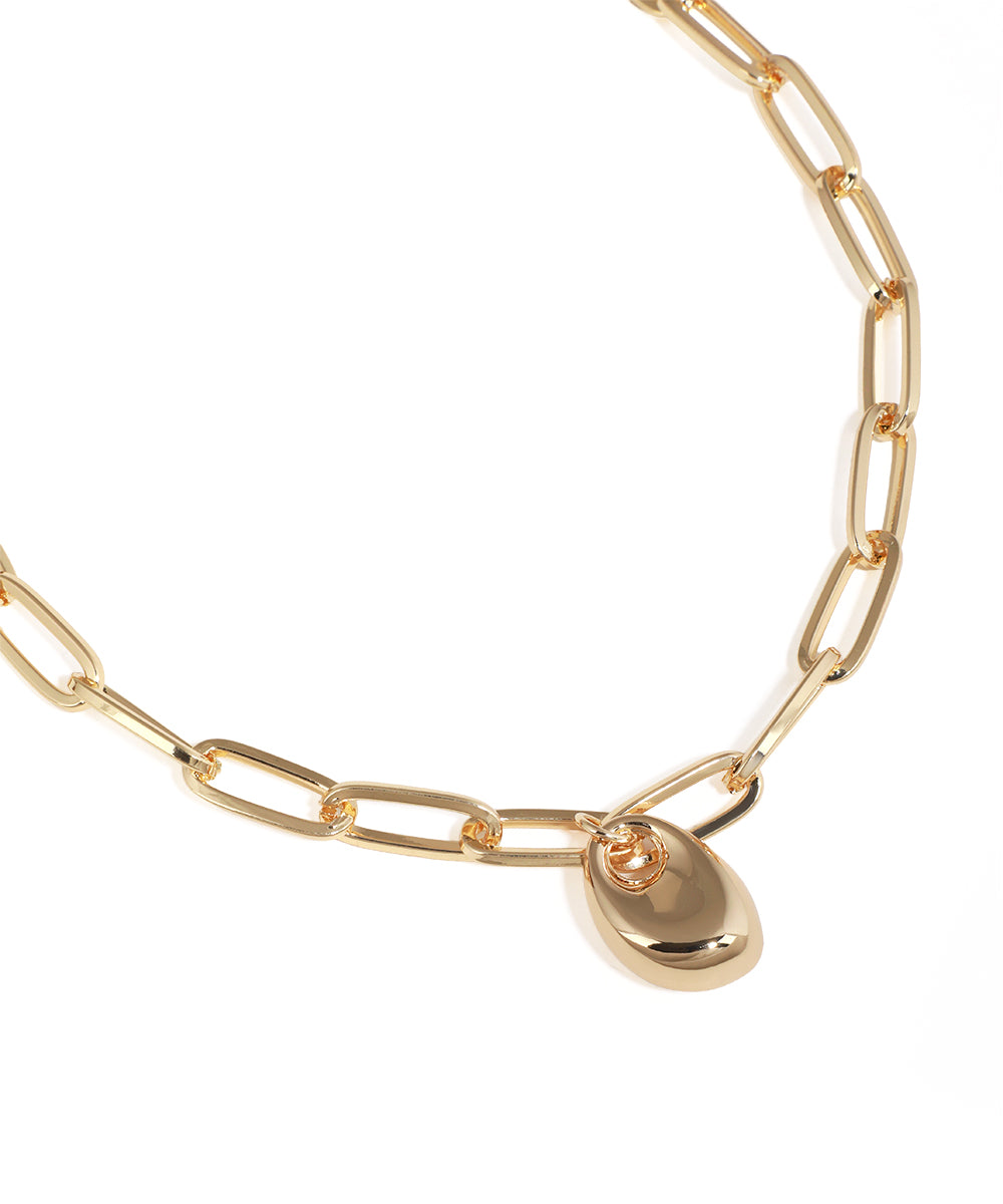 Gold chain necklace with a teardrop pendant on a white background