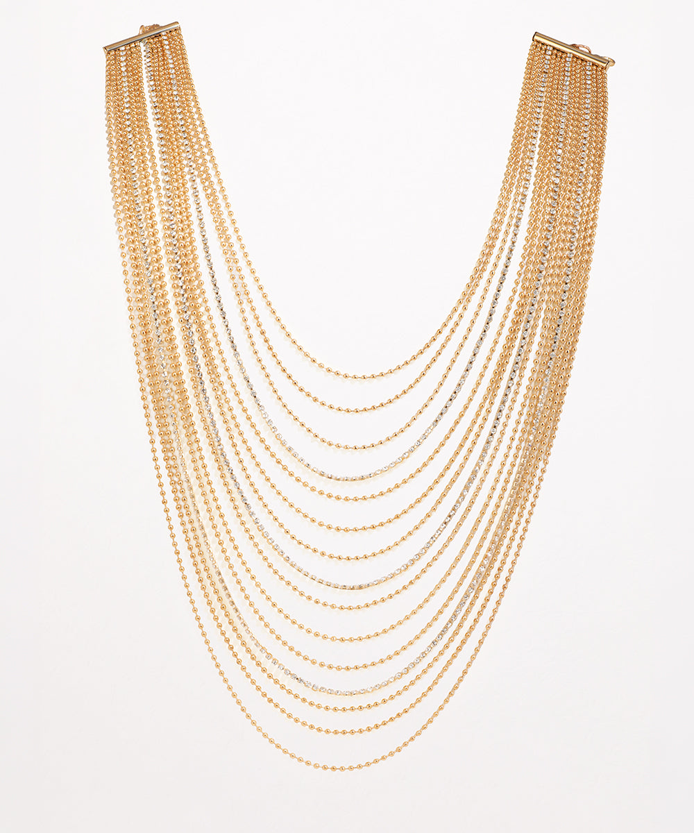 Gold-tone and rhodium finish multi-strand necklace with cascading chains and delicate clear stones.