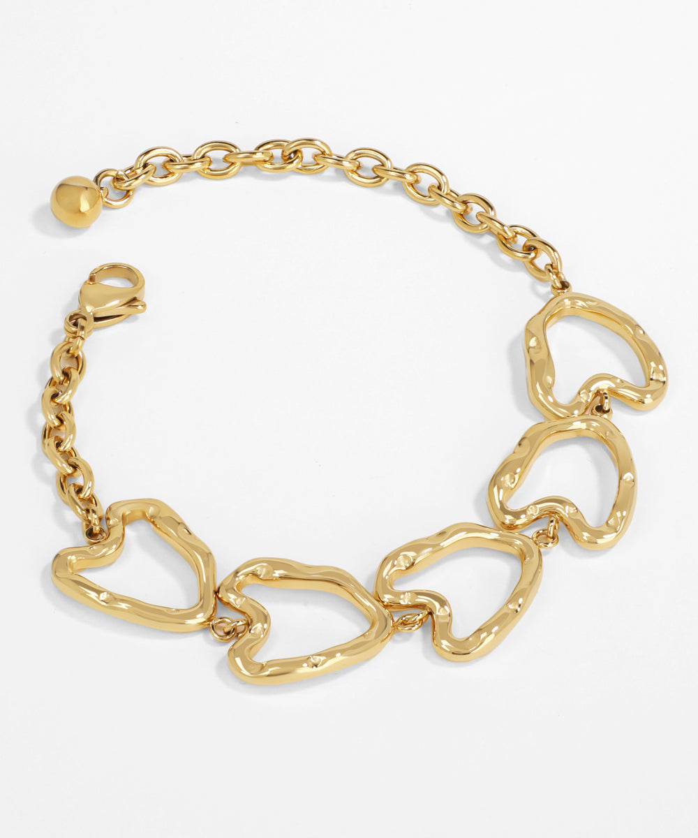 Gold chain bracelet with heart-shaped links on a white background