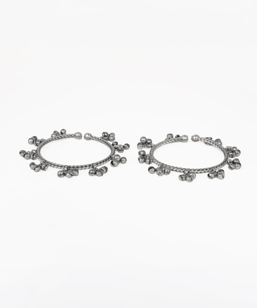 Oxidised silver-tone bangle bracelet pair with twisted band and small hanging ghungroo charms