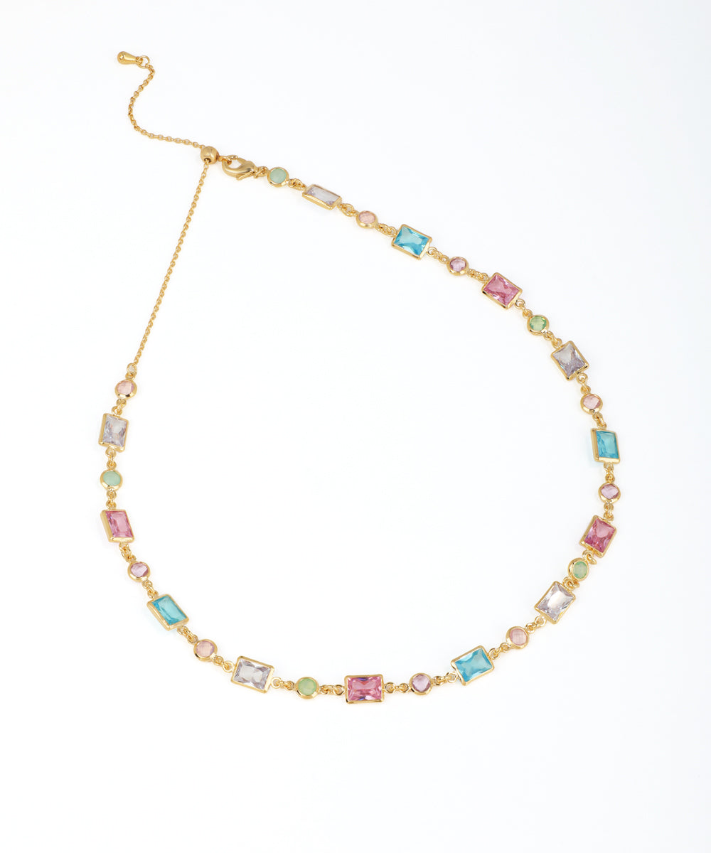 Gold-tone necklace with spaced rectangular and round pastel glass crystals and an adjustable slider