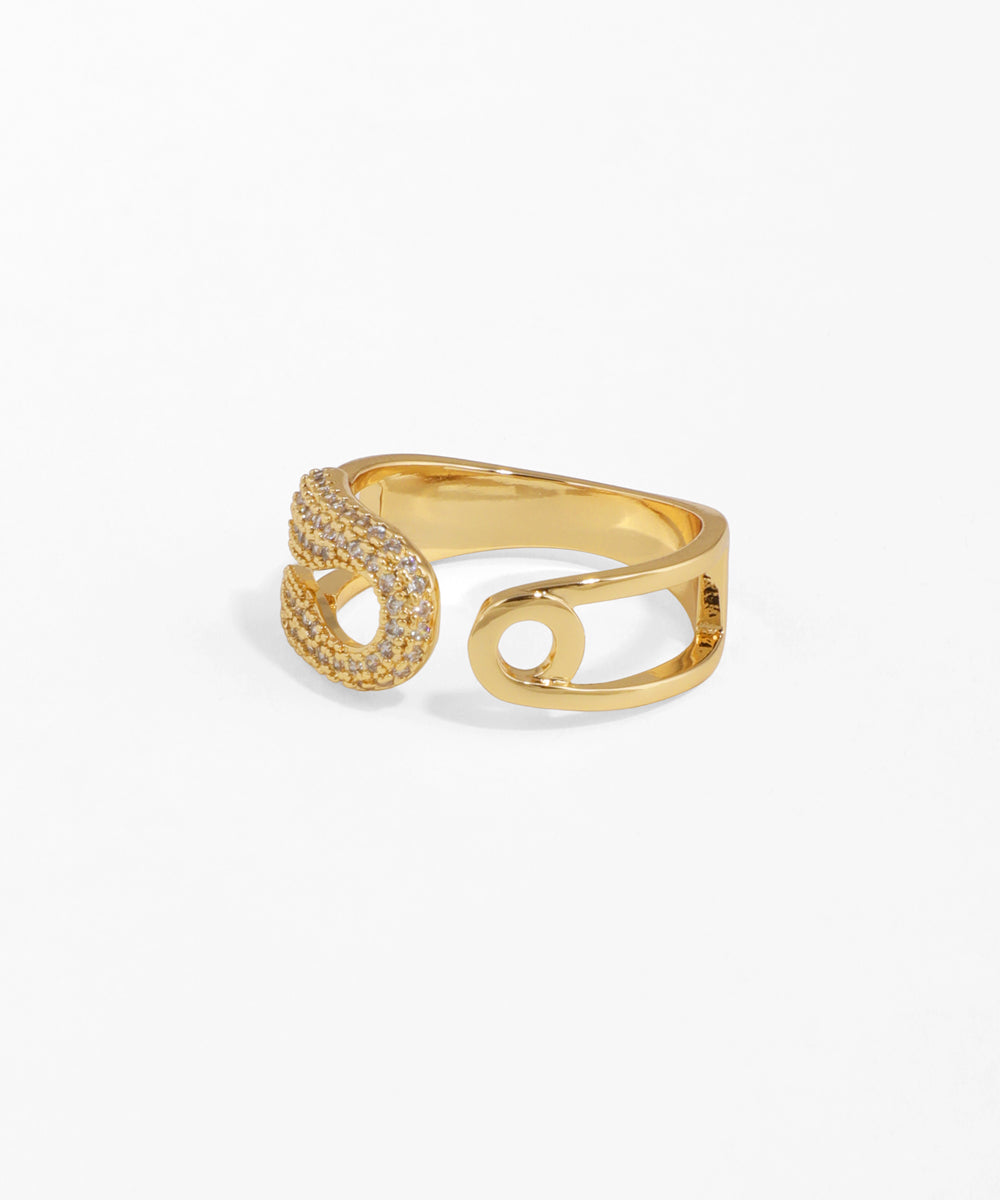 Gold ring with intricate design on a white background
