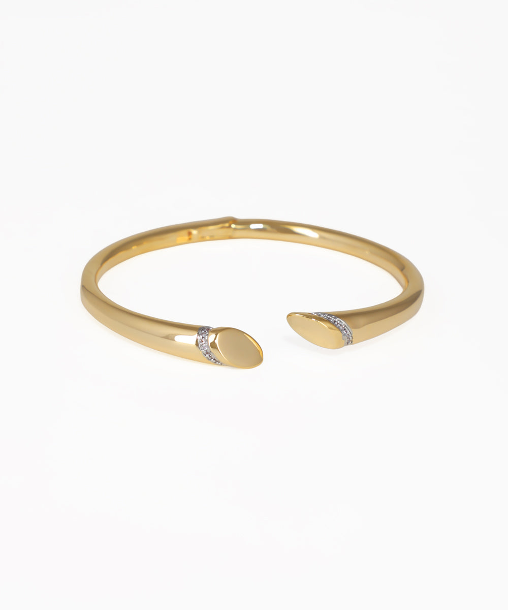 Gold-tone open bangle kada with tapered ends and small clear stones