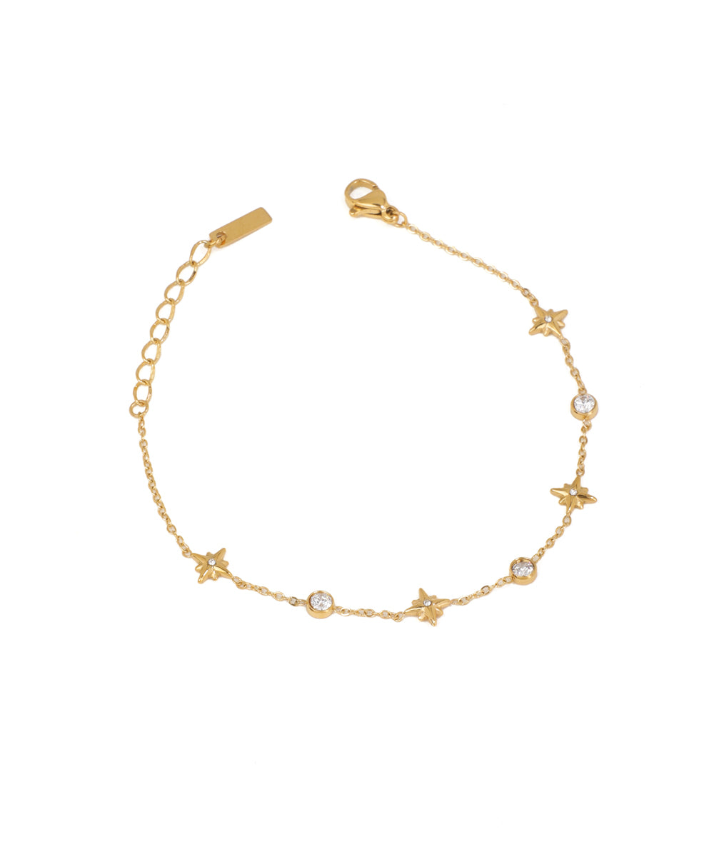 Gold-tone bracelet with alternating star charms and round bezel-set CZ stones on a delicate chain.