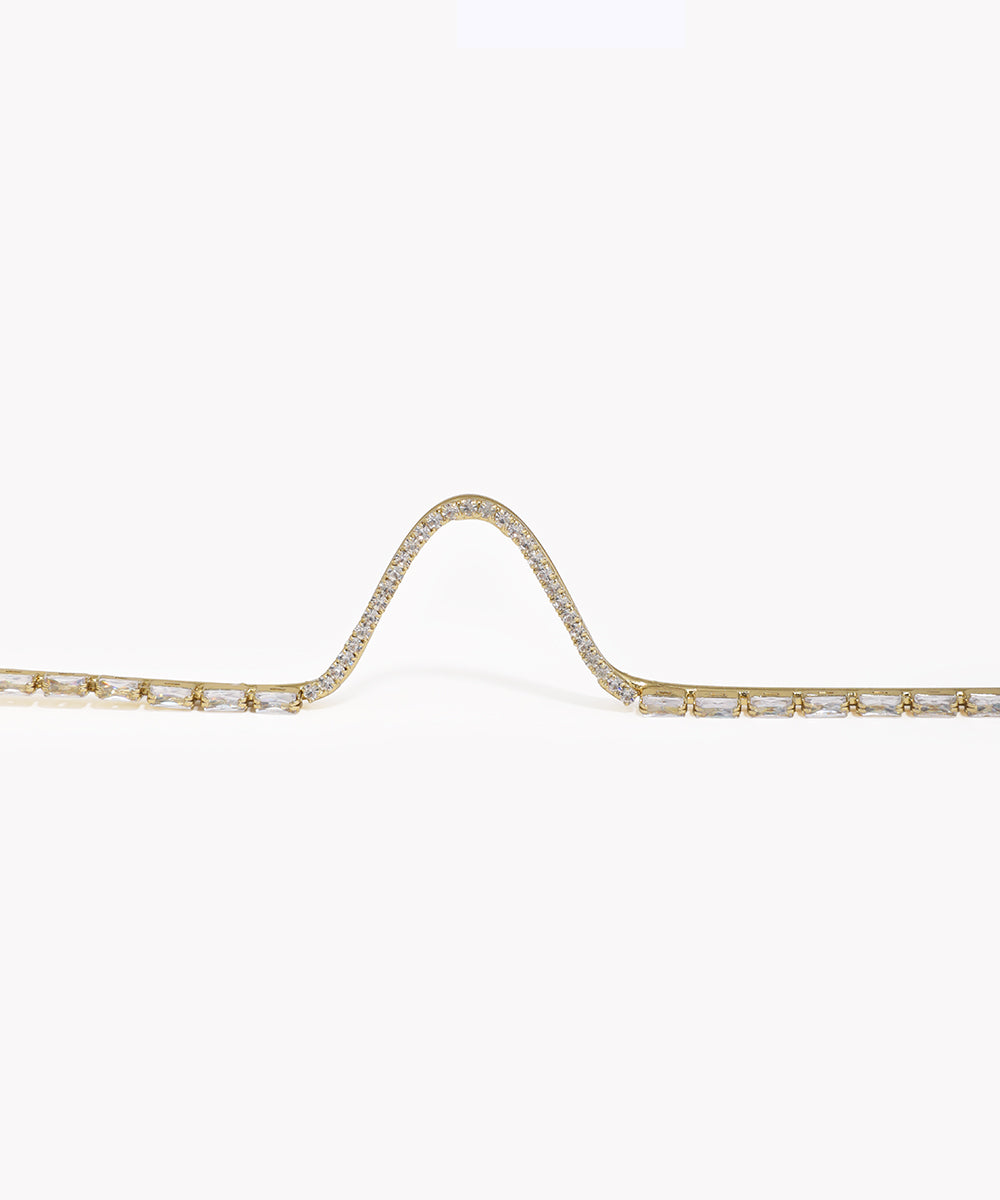 Gold bracelet with diamond accents on a white background