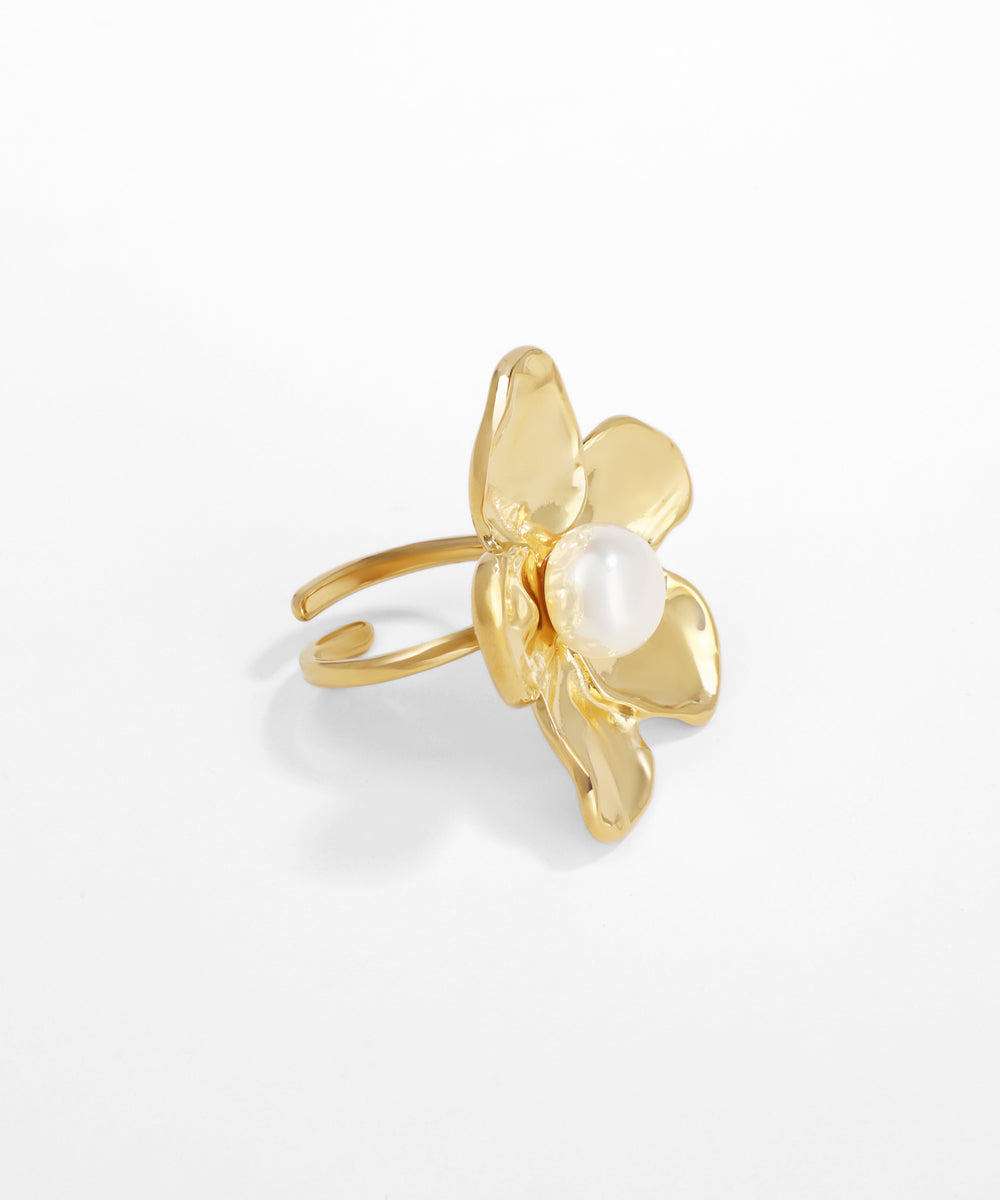 Gold ring with a pearl center on a white background