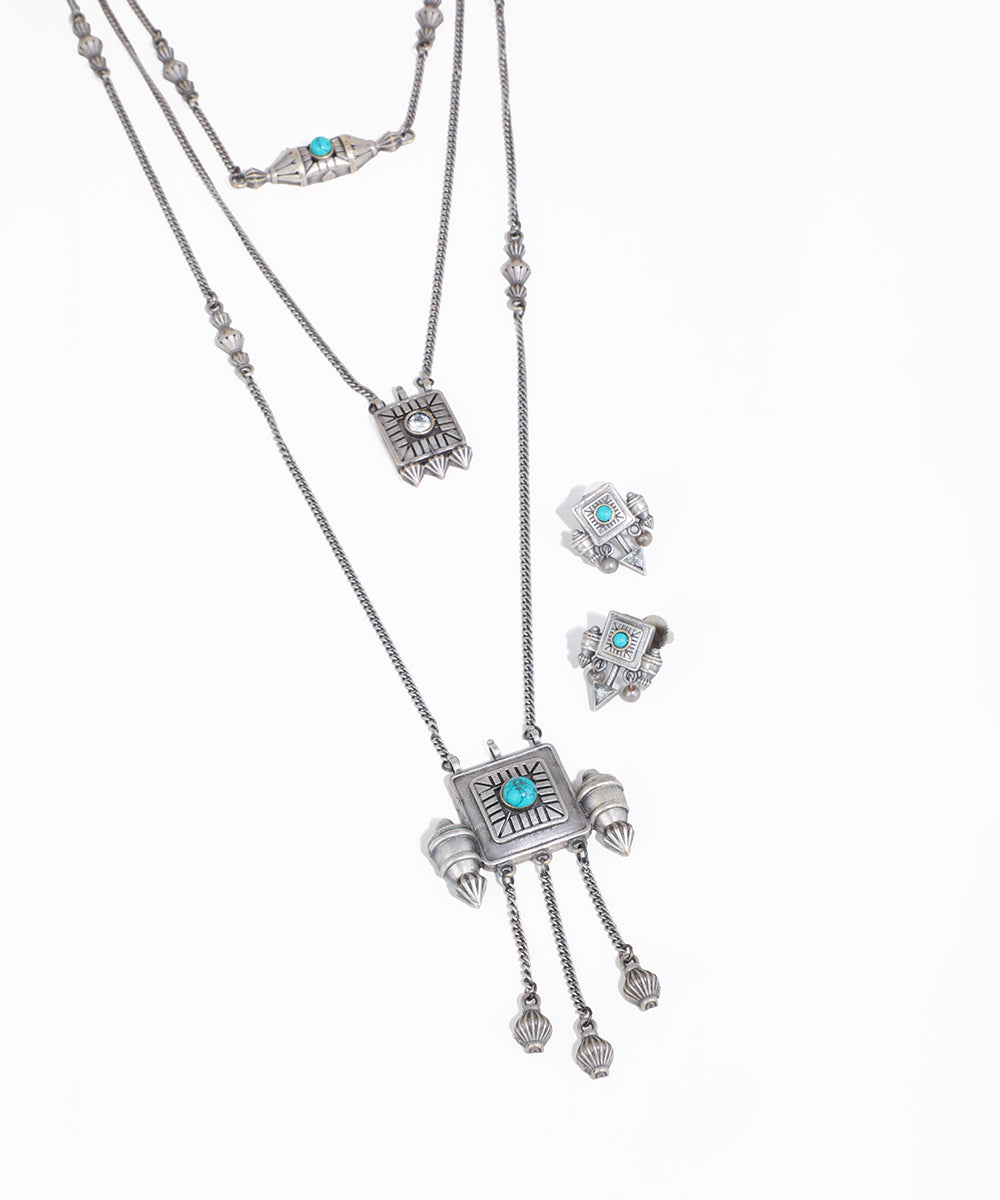 Silver necklace with turquoise stones on a white background
