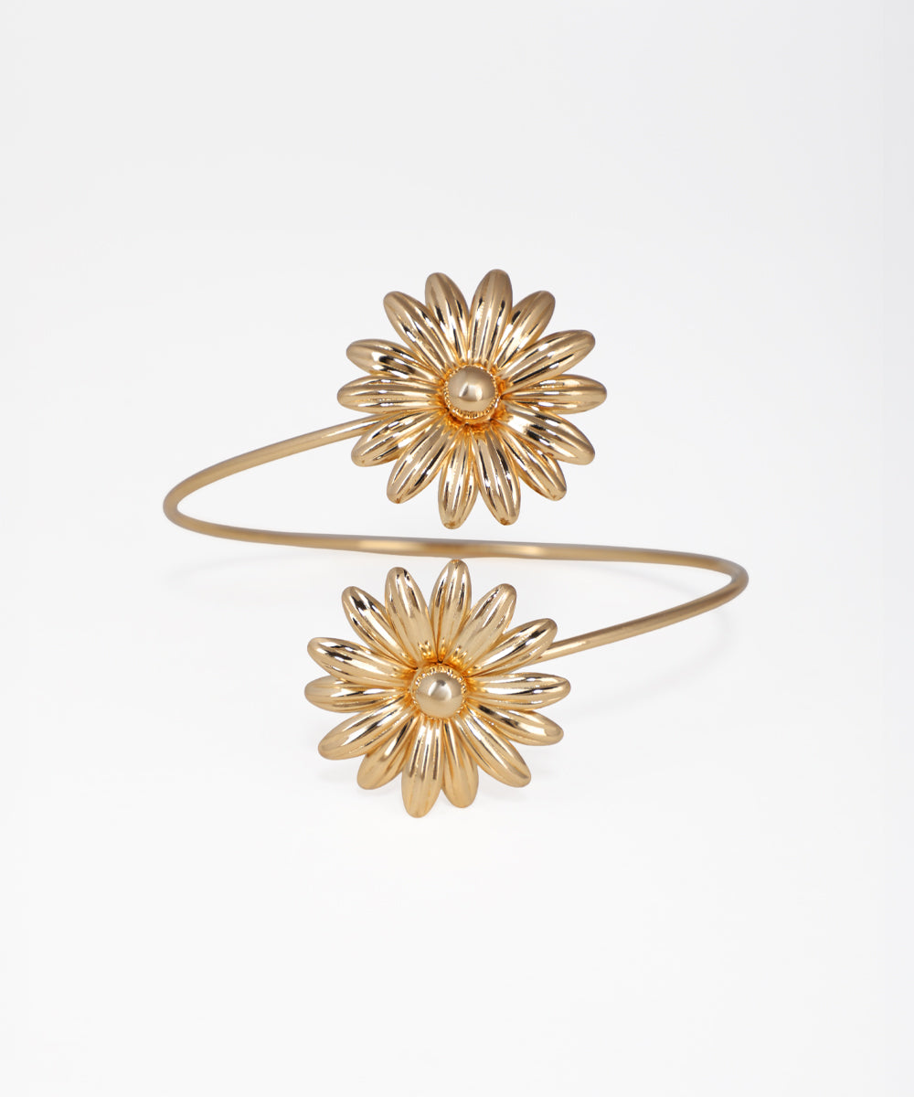Gold flower-shaped bracelet on a white background