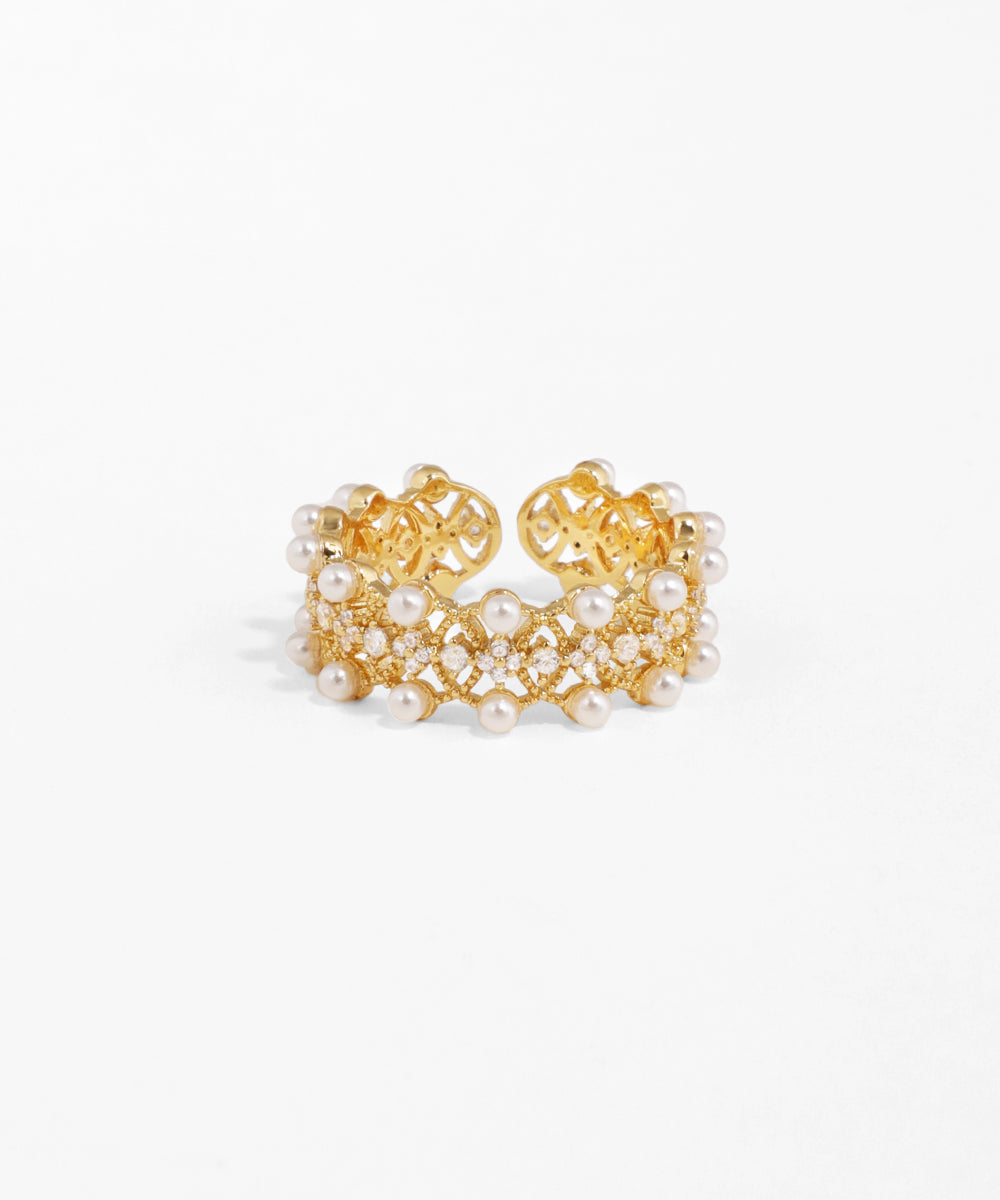 Gold and pearl earrings on a white background