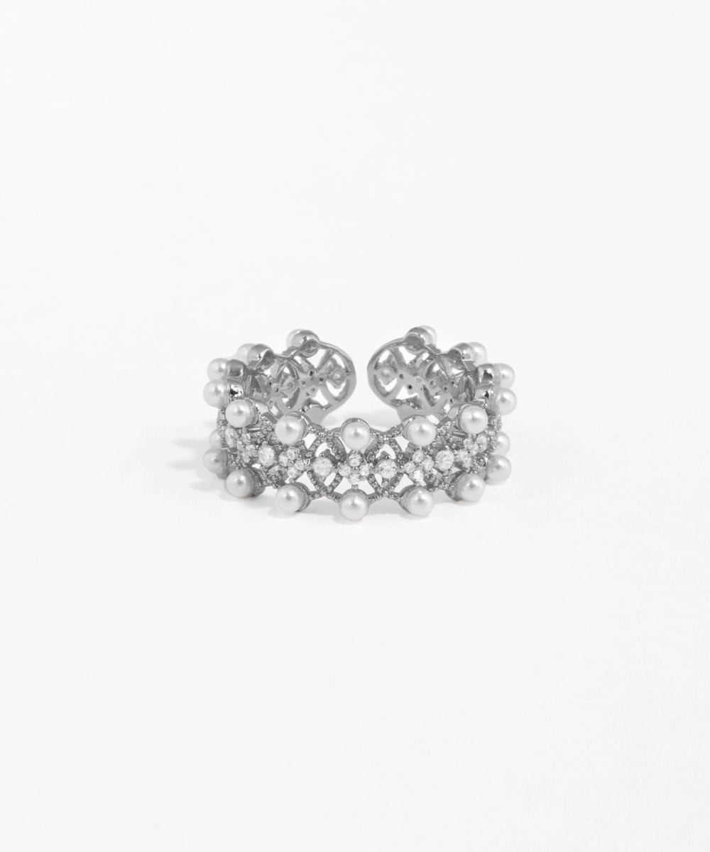 Silver ring with pearls on a white background