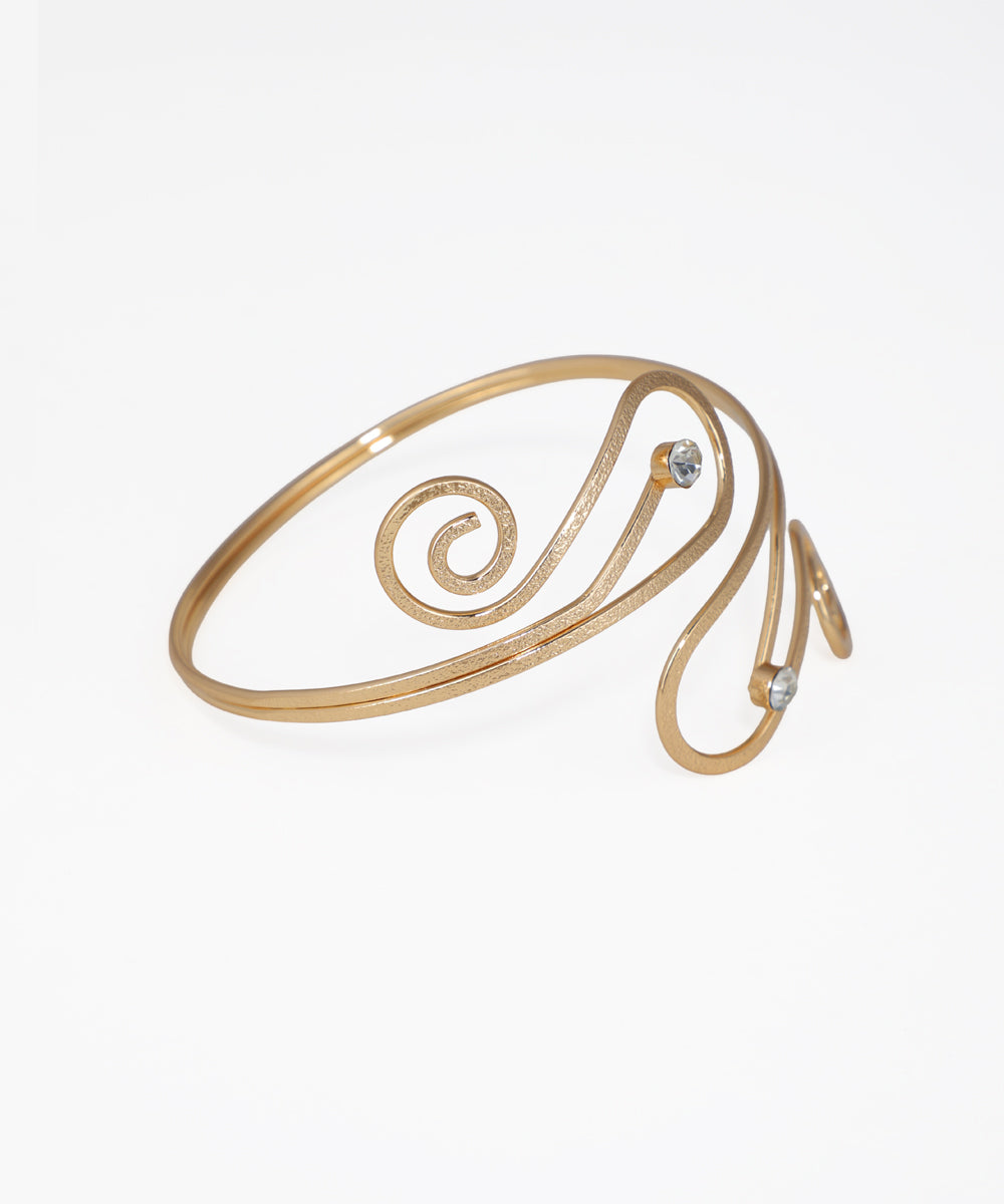 Gold spiral bracelet on a white background