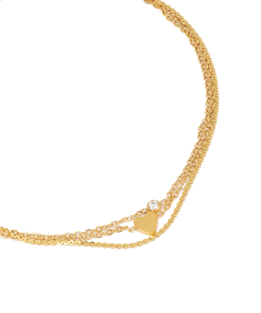 Gold necklace with multiple chains on a white background